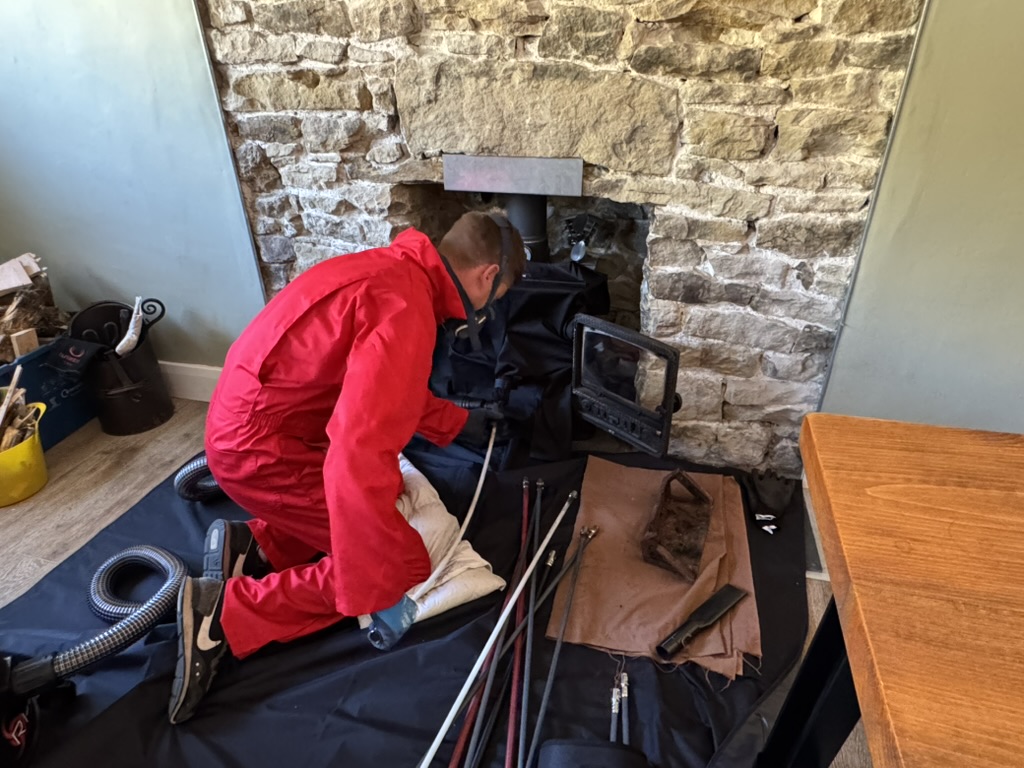 Chris sweeping a chimney